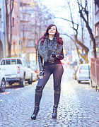 Jeny poses on a city street wearing just a stylish jacket, black seamless pantyhose and tall boots, her feminine curves and private areas fully on display